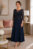 Navy mother of the bride tea-length crepe dress with intricate beaded lace bodice, sheer illusion neckline, three-quarter sleeves, and flowing A-line skirt on a mature brunette model in an elegant indoor boutique setting.