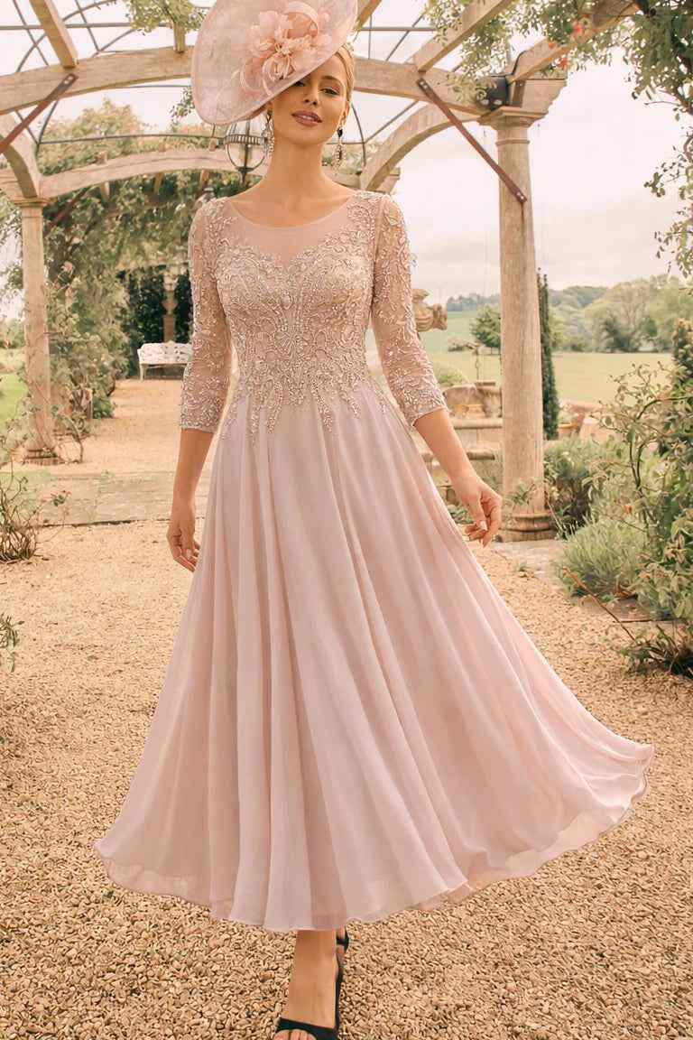 Soft peach pink tea length mother of the bride dress with beaded lace bodice and chiffon skirt