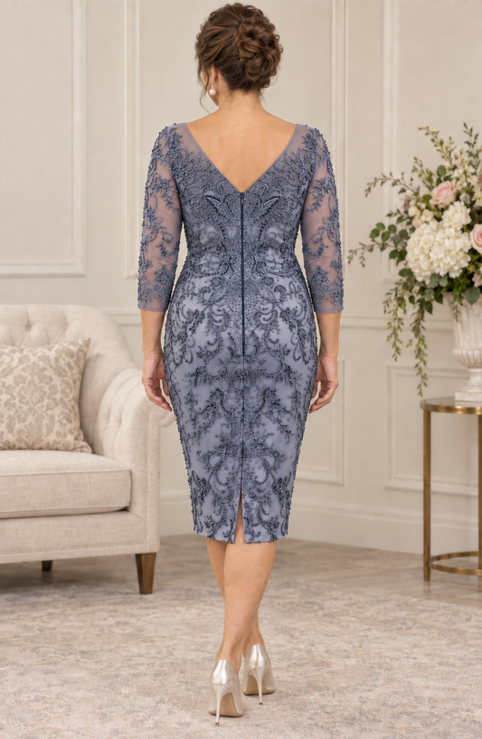 Back view of a blue-grey beaded occasion dress with a V-shaped neckline, centre-back zip and small skirt vent.