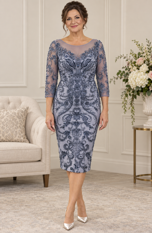 Mature brunette model wearing a blue-grey fully beaded dress with an illusion neckline and sheer three-quarter sleeves at Ever Elegant.