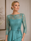 Close-up of Sonia Peña aqua formal gown featuring intricate lace bodice, sheer neckline and elegant waist detail for mothers of the bride and groom