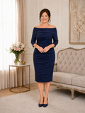 Dark navy off-the-shoulder mother of the bride dress with three-quarter sleeves and layered ruched detailing