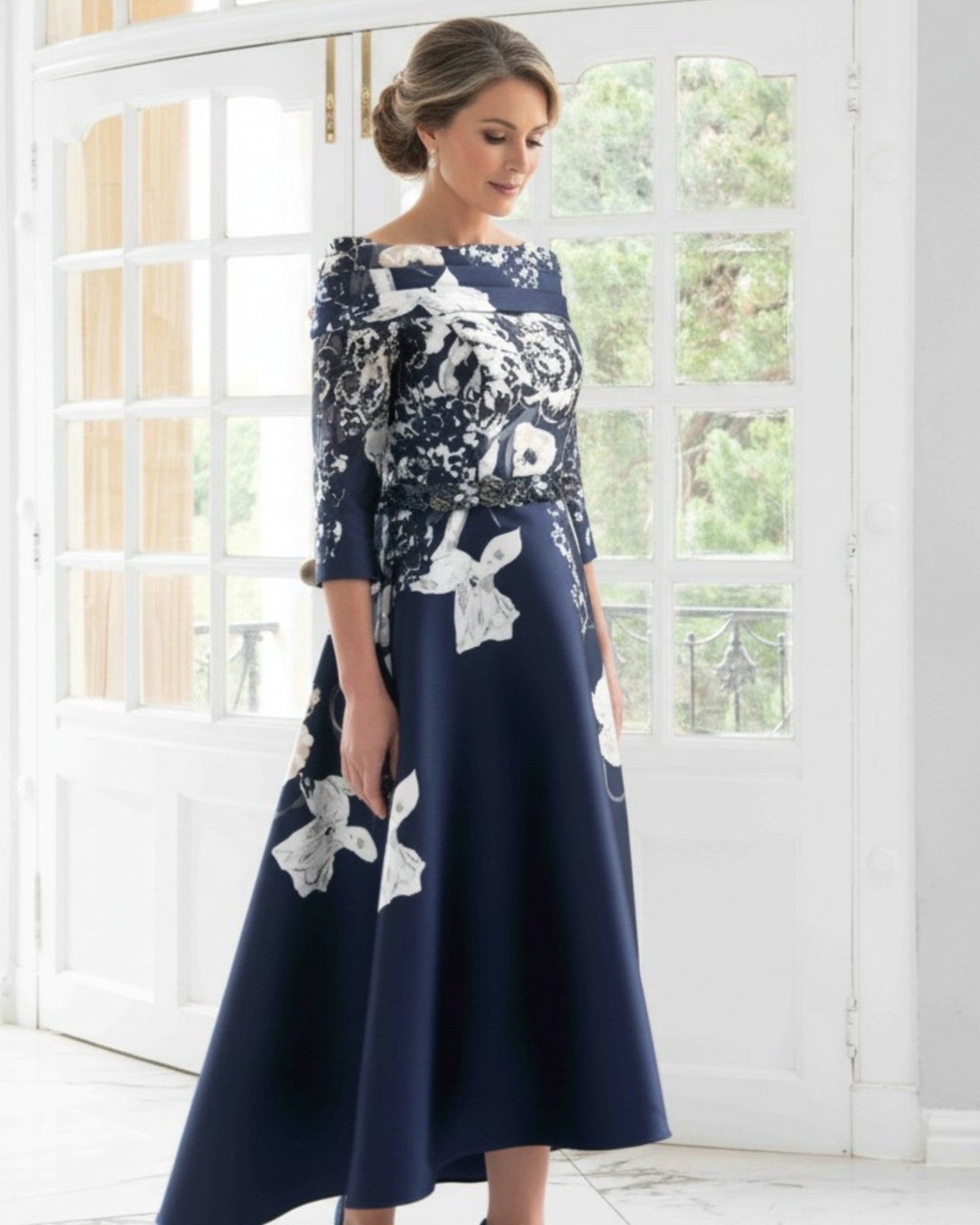 Navy brocade mother of the bride dress with 3/4 sleeves and  waterfall hemline from Irresistible