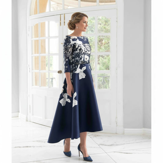 Mother of the bride dress in a floral brocade with a bardot neckline and a high low hemline.