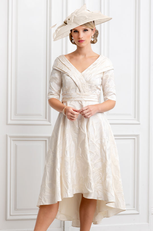 Large cream hatinator with bow and feather detail perfect mother of the bride, groom or racewear hat.