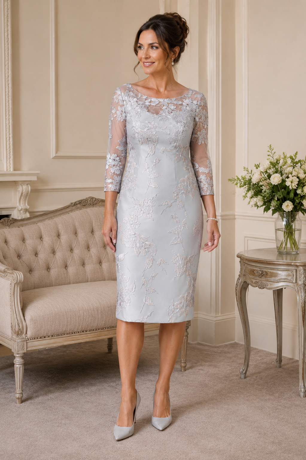 Silver brocade mother of the bride dress with sheer embroidered three-quarter sleeves and elegant below-knee length
