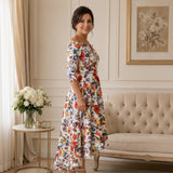Side view of floral high-low mother of the bride dress with a fitted bodice and softly flared A-line skirt.