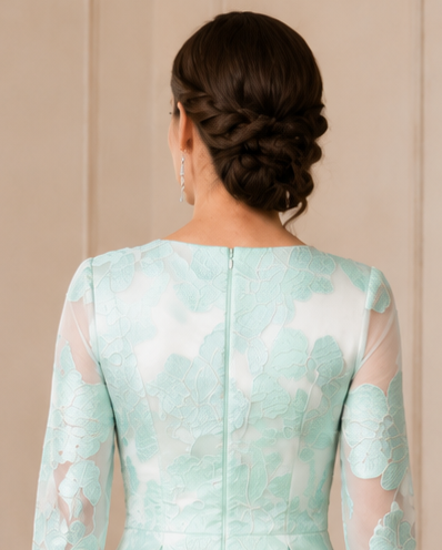 Back view of mint floral occasion dress with high neckline, central zipper and full circular skirt.