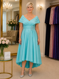 Veromia plus size mother of the bride dress in turquoise, elegant high-low occasion dress with off-shoulder neckline, beaded waist detail and flowing skirt, shown on a mature size 18 model in Ever Elegant Melbourne boutique
