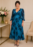 Plus size teal and navy floral mother of the bride dress with sleeves on mature model – wedding guest occasion wear Melbourne