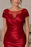 Elegant red wedding guest dress in stretch taffeta with lace bodice detail and fitted knee-length silhouette
