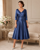 Mid blue stretch taffeta dress with V back neckline, single collar and A-line skirt on brunette model