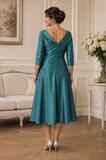 Back view of Ispirato deep jade stretch taffeta dress with V neckline and angled waist seam