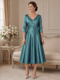 Ispirato ISH822 deep jade stretch taffeta mother of the bride dress on brunette model in elegant indoor setting