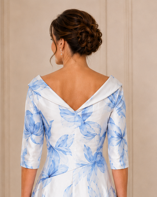 Back image of a  ivory and blue dress  with a v neckline and elbow length sleeves that would suit any occasion