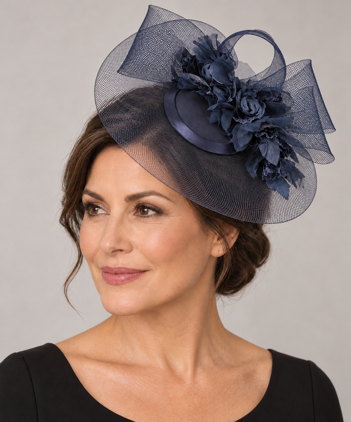 Cupids K5021 navy fascinator worn beside the crown by a mature model
