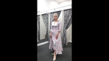 video of a silver and brocade mother of the bride dress with a fitted top,3/4 sleeves and middy length skirt.