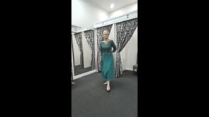 Video of a Designer beaded teal formal dress with ¾ sheer sleeves and illusion neckline